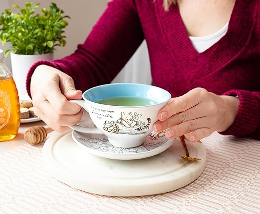 Silver Buffalo Disney Winnie the Pooh Walking Classic Scene Ceramic Teacup and Saucer, 12 Ounces